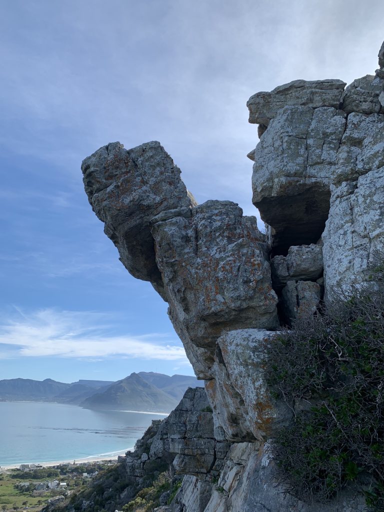 Unstable overhanging rock above the Cape Town coast, secured for safe removal by Cape Town Metro